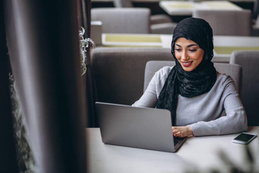 arabian woman hijab inside cafe working laptop scaled 1