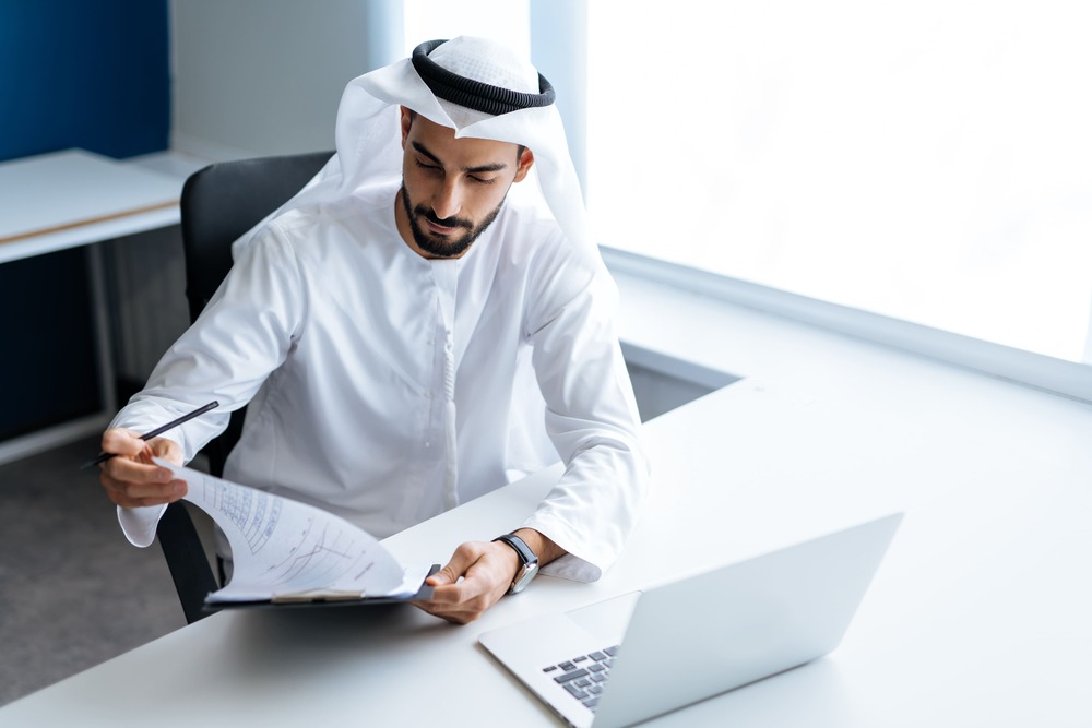 handsome man with dish dasha working his business office dubai 2 2 1
